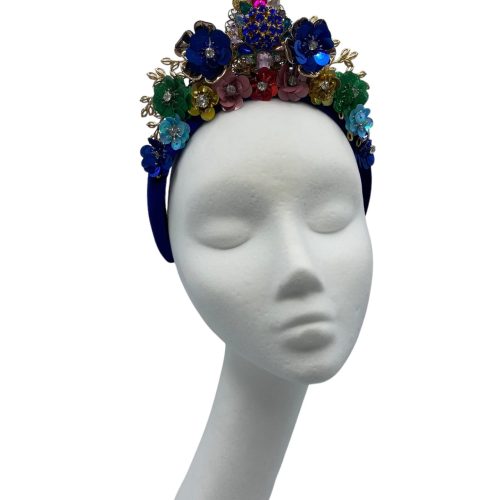 Stunning blue velvet headpiece with an array of coloured embellishments.